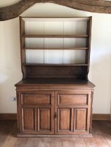 An early 20th century oak bookcase with open shelves over cupboards, on block base, 50" wide x 23"