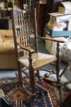 A Lancashire oak and ash spindle back and rush envelope seat rocking chair