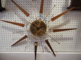 A Paico 1960s star-shaped clock with brass dial and Arabic numerals