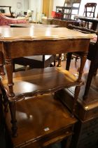 An early 20th century walnut work table with lift-up lid and undertier, on turned supports, 25" wide