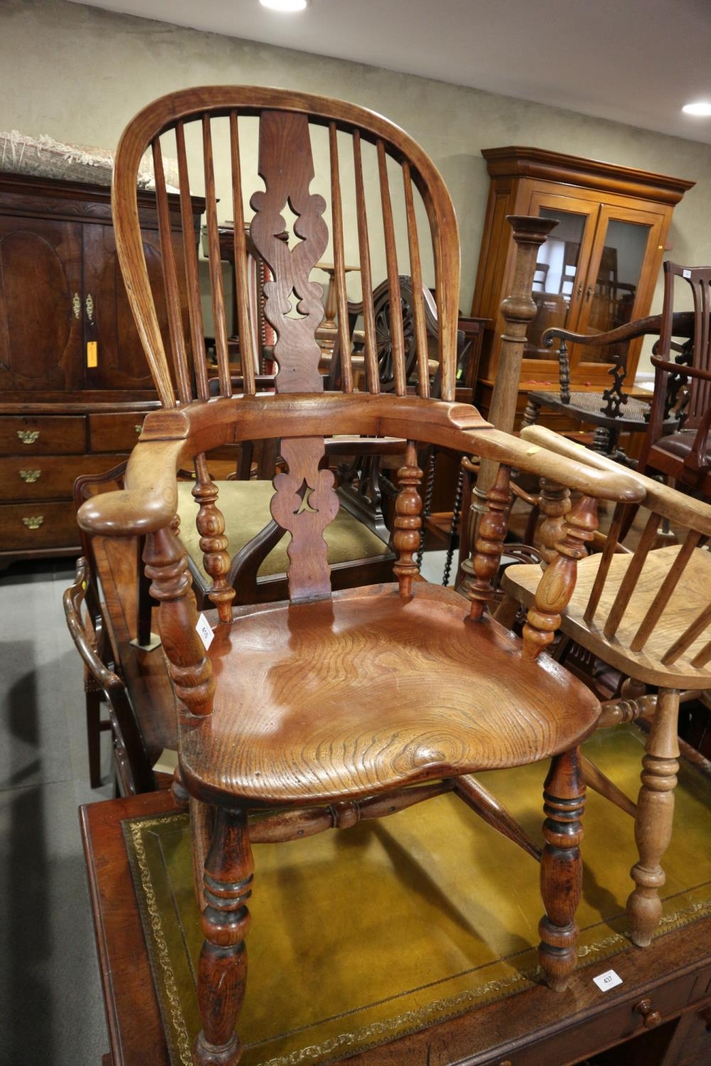 A Lancashire oak, ash and elm elbow chair with panel seat, on turned and stretchered supports