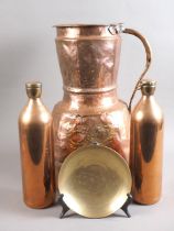An Iranian goat herder's copper milk jug, 16" high, two copper hot water bottles and an engraved