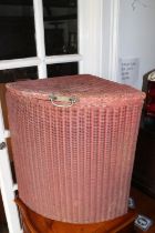 A Lloyd Loom quadrant linen basket with original pink paint, 22" wide x 15" deep x 23" high, and a