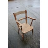 An Oxford bar back elbow chair with elm seat, on turned supports