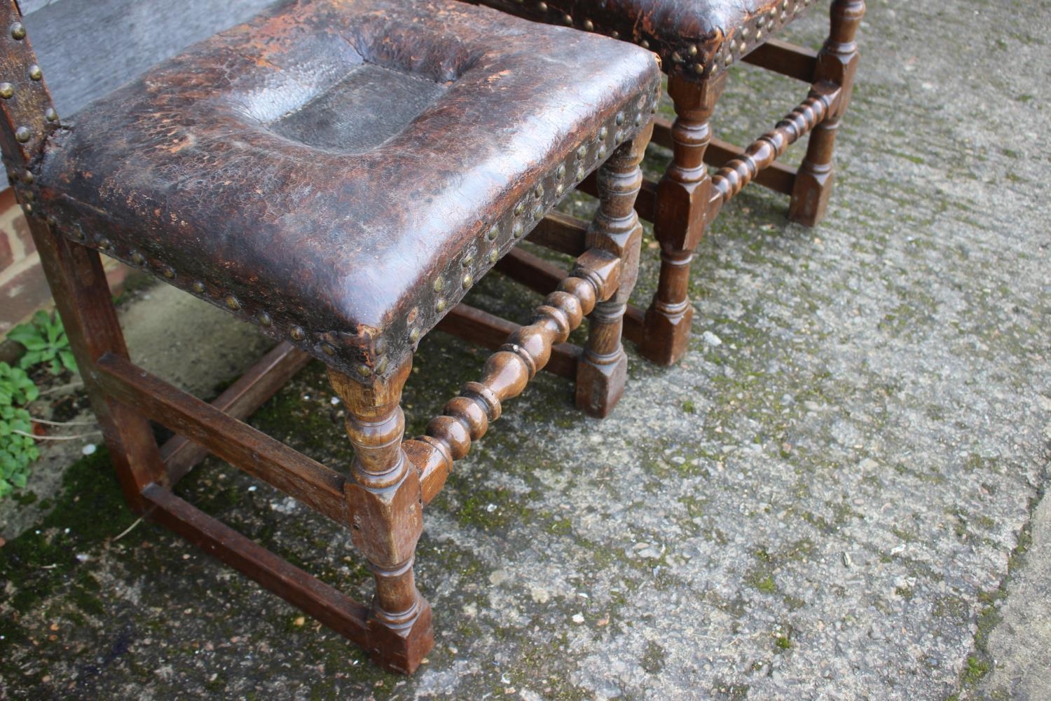 A pair of 18th century oak chairs with seats and back upholstered in a brown leather, on turned - Image 4 of 4