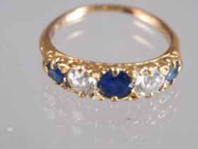 An Edwardian yellow metal sapphire and white stone five stone ring, stamped 18ct, ring size P, 3.