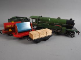 A Hornby O gauge locomotive "2750 Papyrus" with LNER fender, a Shell "BP" oil wagon and two others