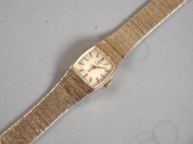 A lady's Omega wristwatch with 9ct gold case and strap with textured decoration, 27.5g gross