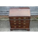 A mid 18th century mahogany two-section fall front bureau, the interior fitted drawers and pigeon