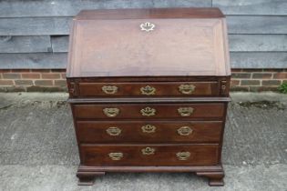 A mid 18th century mahogany two-section fall front bureau, the interior fitted drawers and pigeon