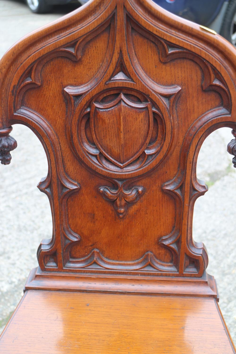 A 19th century carved oak hall chair with Gothic blind fret back and panel seat, on turned supports - Image 2 of 2