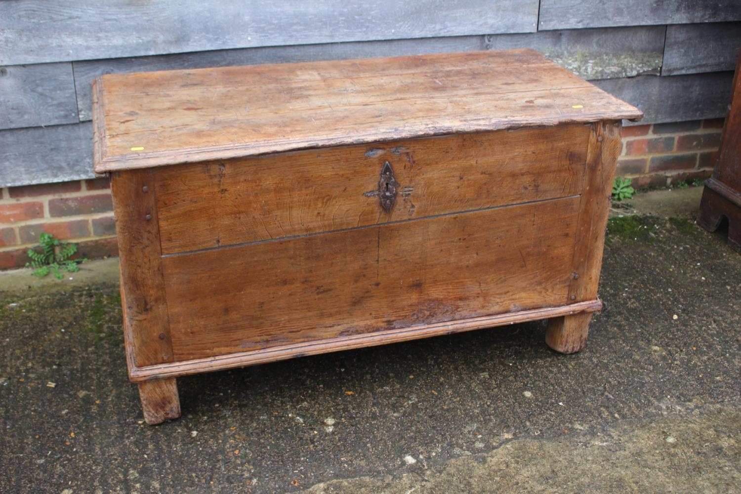 An early 18th century Hanseatic planked oak coffer, the interior fitted candle box, on stile