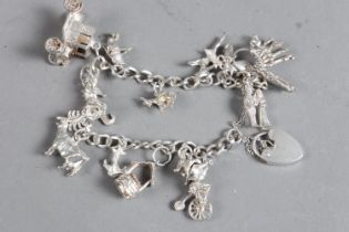 A silver charm bracelet with various charms, 1.2oz troy approx