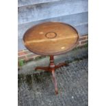 An early 19th century mahogany and inlaid circular top occasional table, on tripod splay supports,