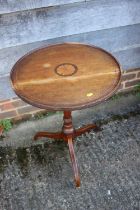 An early 19th century mahogany and inlaid circular top occasional table, on tripod splay supports,