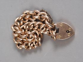 A 9ct rose gold curb link bracelet with heart shaped clasp, 18.7g