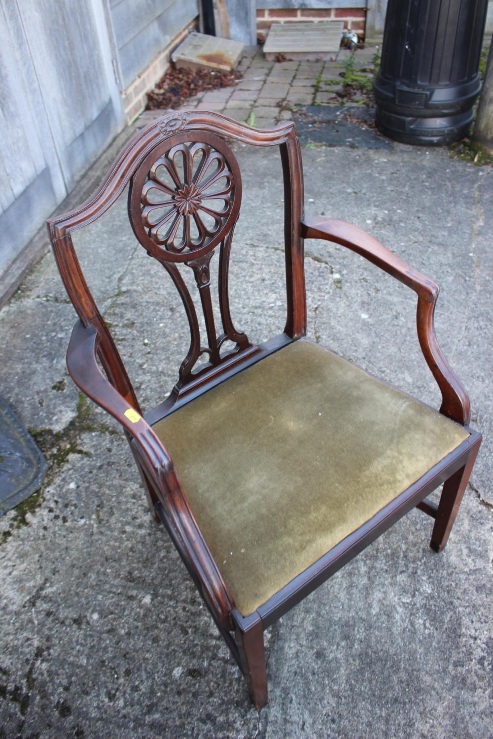 An early 19th century mahogany carver chair of Hepplewhite design with pierced splay and drop-in