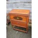 An oak side cabinet with lift-up lid and drop-down compartment, on turned and stretchered