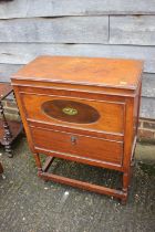 An oak side cabinet with lift-up lid and drop-down compartment, on turned and stretchered