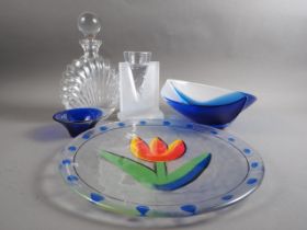 A Mats Jonasson blue glass bowl, a similar companion bowl and a Kosta Boda enamelled plate by