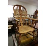 A Lancashire oak, ash and elm elbow chair with panel seat, on turned and stretchered supports