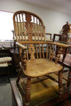 A Lancashire oak, ash and elm elbow chair with panel seat, on turned and stretchered supports