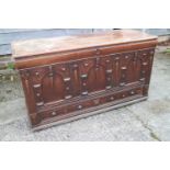 An early 18th century oak mule chest with applied mouldings and arcaded front over one long drawer