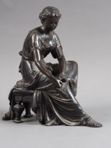 Duchoiselle: a 19th century French patinated bronze figure of a classical woman adjusting her