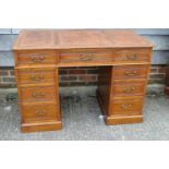 An Edwardian oak double pedestal desk, by Heal & Son London, with tooled and gilt brown leather