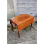 A 19th century mahogany Pembroke table, fitted one drawer, on square tapered castored supports , 32"