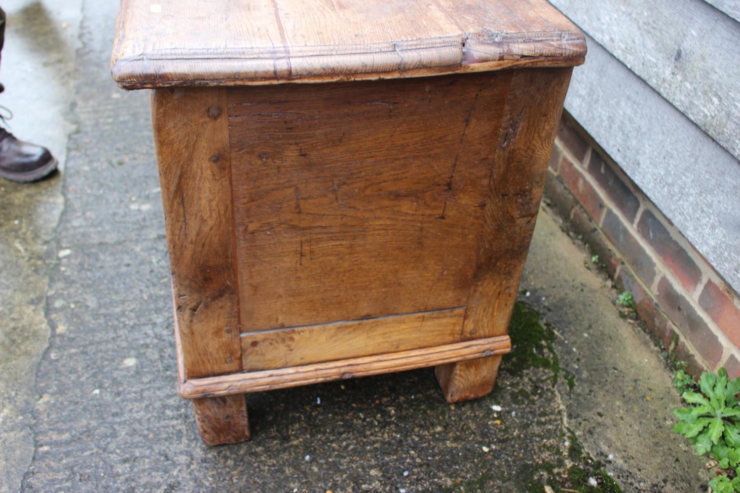 An early 18th century Hanseatic planked oak coffer, the interior fitted candle box, on stile - Image 5 of 5