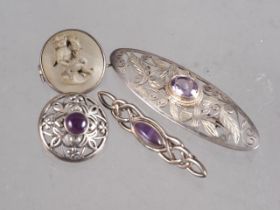 A lava cameo brooch and three silver brooches