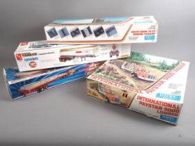 An ERTL blueprint 1/25 scale model kit, International Paystar 5000 Logger, and three similar