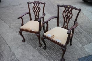 A pair of late 19th century mahogany carver dining chairs of Chippendale design with drop-in