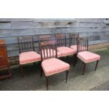 A set of six Regency mahogany and line inlaid standard dining chairs with padded seats,