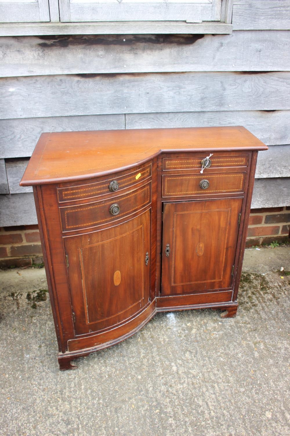 An Edwardian mahogany box and ebony strung shape front corner unit, fitted four drawers, over