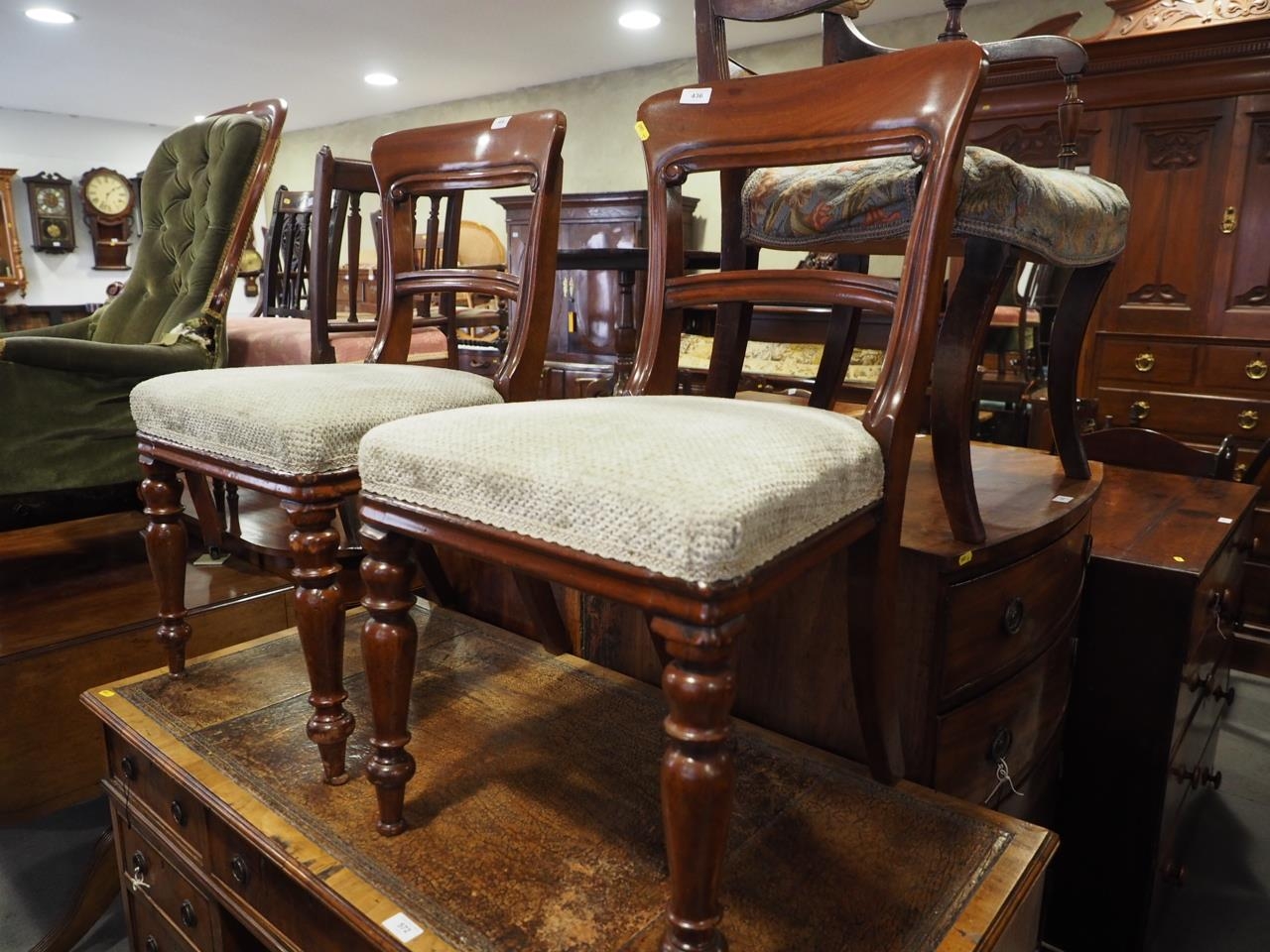 A pair of mid Victorian mahogany bar back dining chairs with stuffed over seats, on turned supports