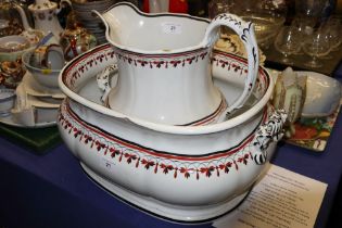 A 19th century "Semi Porcelain" hot water jug and matching foot bath (chip to rim)