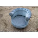 A tub shape low seat occasional chair, upholstered in a blue fabric, on square taper supports