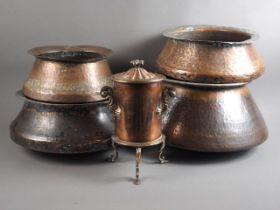 Four Indian hammered copper cooking pots, largest 15" dia, smallest 11" dia, and a copper hot