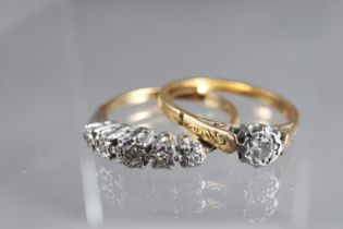 An 18ct gold and platinum five stone illusion set ring, size M, 2.3g, and a similar yellow metal