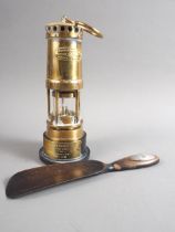 A Thomas and Williams Ltd safety lamp, on presentation stand, and an ebonised shoehorn with silver