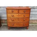 A Victorian mahogany bowfront chest of two short and three long drawers with turned knob handles and