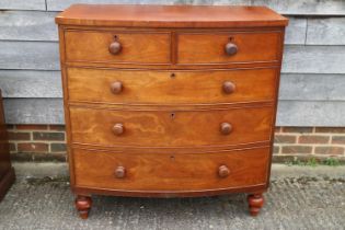 A Victorian mahogany bowfront chest of two short and three long drawers with turned knob handles and