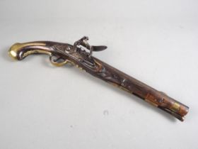 An 18th century flintlock pistol with brass mounts and monogram to stock barrel, 11 1/2" long