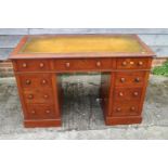 A 19th century walnut double pedestal desk with tooled leather lined top over nine drawers, on block