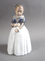 A Royal Copenhagen figure of a standing Amager girl, No 1251, 8" high