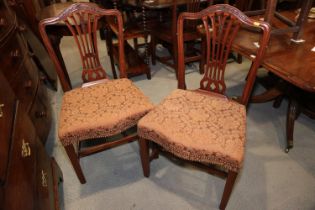 A pair of Georgian mahogany hump back dining chairs of Hepplewhite design with serpentine stuffed