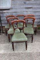 A set of six Victorian mahogany loop back standard dining chairs, on turned supports