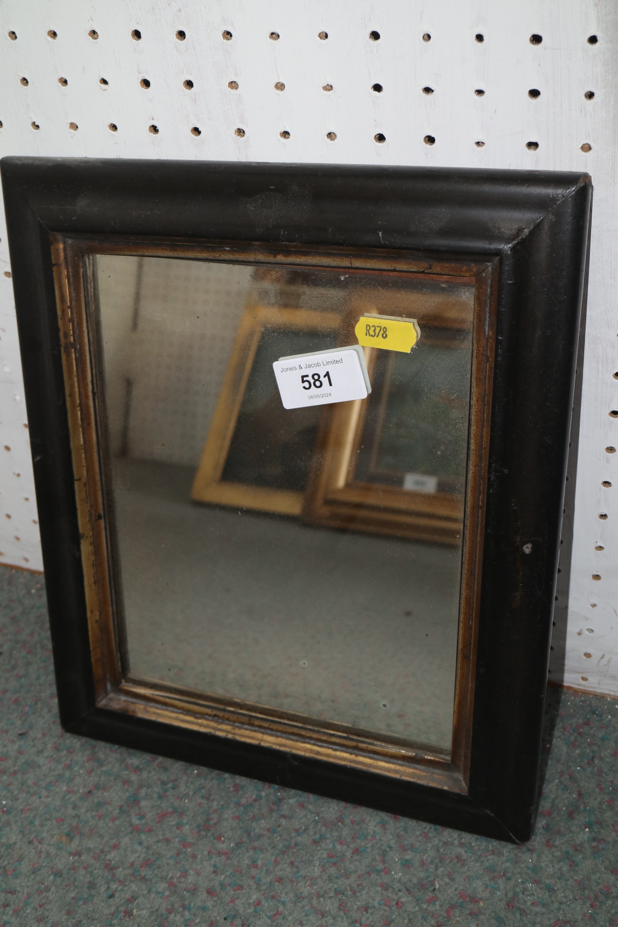 A rectangular wall mirror in ebonised  and gilded  frame, plate 6 3/4" x 8 3/4"